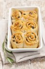Olive yeast pastries in white dish over towel — Stock Photo