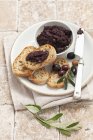 Tapenade with slices of bread — Stock Photo