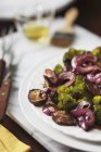 Roasted broccoli and shitake mushrooms on a serving platter — Stock Photo