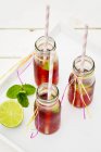 Bottles of iced tea with lime and peppermint — Stock Photo