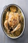 Roasted chicken with lemon and white beans — Stock Photo