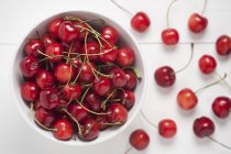 Fresh cherries in white bowl — Stock Photo