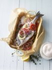 Seabream in a salt crust ready to fry over wooden surface — Stock Photo