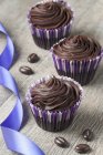 Three chocolate ganache cupcakes — Stock Photo