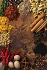 Assorted spices on wooden board — Stock Photo