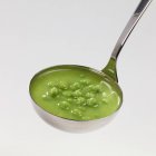 Pea soup in ladle — Stock Photo