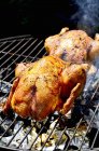 Chickens on smoking barbecue — Stock Photo