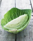 Wedge of white cabbage in leaf — Stock Photo