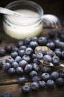 Blueberries with bowl of yogurt — Stock Photo