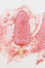 Melting strawberry ice cream stick — Stock Photo