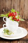 Strawberries with flowers and leaves — Stock Photo