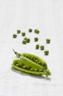 Fresh green pods and peas — Stock Photo