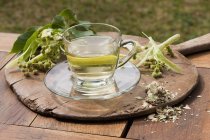 Lime flower tea in glass cup — Stock Photo
