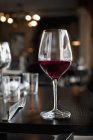 Glass of red wine on table — Stock Photo