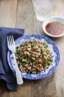 Elevated view of cereal salad with nuts, vegetables, soy and ginger dressing — Stock Photo