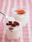 Glass of yoghurt with raspberries — Stock Photo