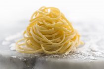 Nest of fresh linguine pasta — Stock Photo