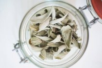 Closeup top view of dried sage leaves in jar — Stock Photo