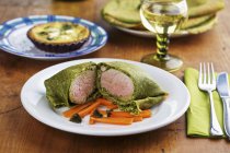 Pork fillet wrapped in herb pancakes — Stock Photo