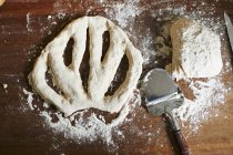 Top view of unbaked Fougasse with flour, dough and spatula — Stock Photo