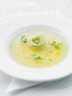 Clear broth with tortellini pasta piece — Stock Photo