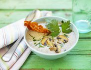 Closeup view of mushroom soup with bacon and herbs — Stock Photo