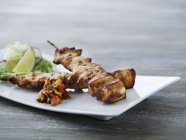 Chicken skewers with relish and salad — Stock Photo