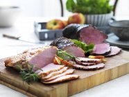 Partly sliced Pork and beef ham — Stock Photo