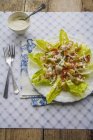 Closeup view of Caesar salad with chicken and bacon — Stock Photo