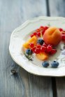 Platter with apricots and redcurrants — Stock Photo