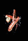 Closeup view of grilled langoustines with crumbles on black background — Stock Photo