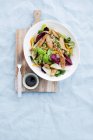 Closeup view of chicken salad with nuts and basil in bowl — Stock Photo