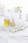 Closeup view of oil and lemons on a laid table — Stock Photo