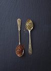 Top view of dried green and red Rooibos tea on spoons — Stock Photo