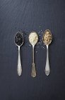 Sesame seeds on three spoons — Stock Photo