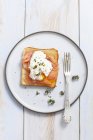 Slice of toast topped with smoked salmon — Stock Photo