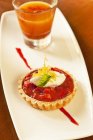 Closeup view of strawberry and rhubarb tartlet with whipped cream — Stock Photo