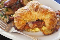 Croissant with scrambled eggs — Stock Photo