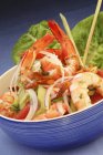 Exotic prawn salad with vegetables in a blue bowl — Stock Photo