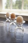 Eggs in upturned glass cups — Stock Photo