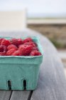 Raspberries in carton box — Stock Photo