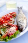 Fish platter with grilled sea bass — Stock Photo