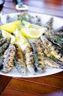 Grilled sardines with lemons — Stock Photo