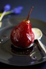 Closeup view of poached pear in red wine — Stock Photo