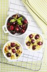 Top view of cherry bakery with pistachios and raw cherries — Stock Photo