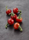 Fresh red Habanero chillis on grey surface — Stock Photo