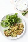 Courgette cakes with a rocket salad — Stock Photo
