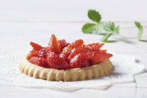 Strawberry tartlet on doily — Stock Photo