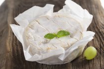 Camembert cheese in paper — Stock Photo