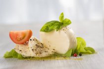 Mozzarella with basil and tomato — Stock Photo